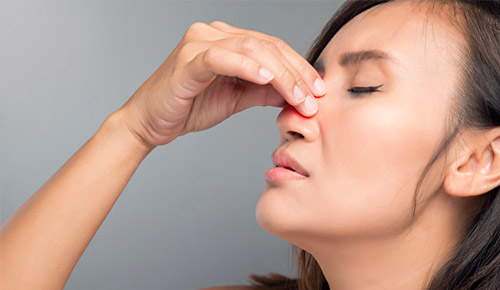 Woman Pinching her nose
