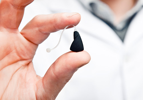Doctor Holding up Hearing aids