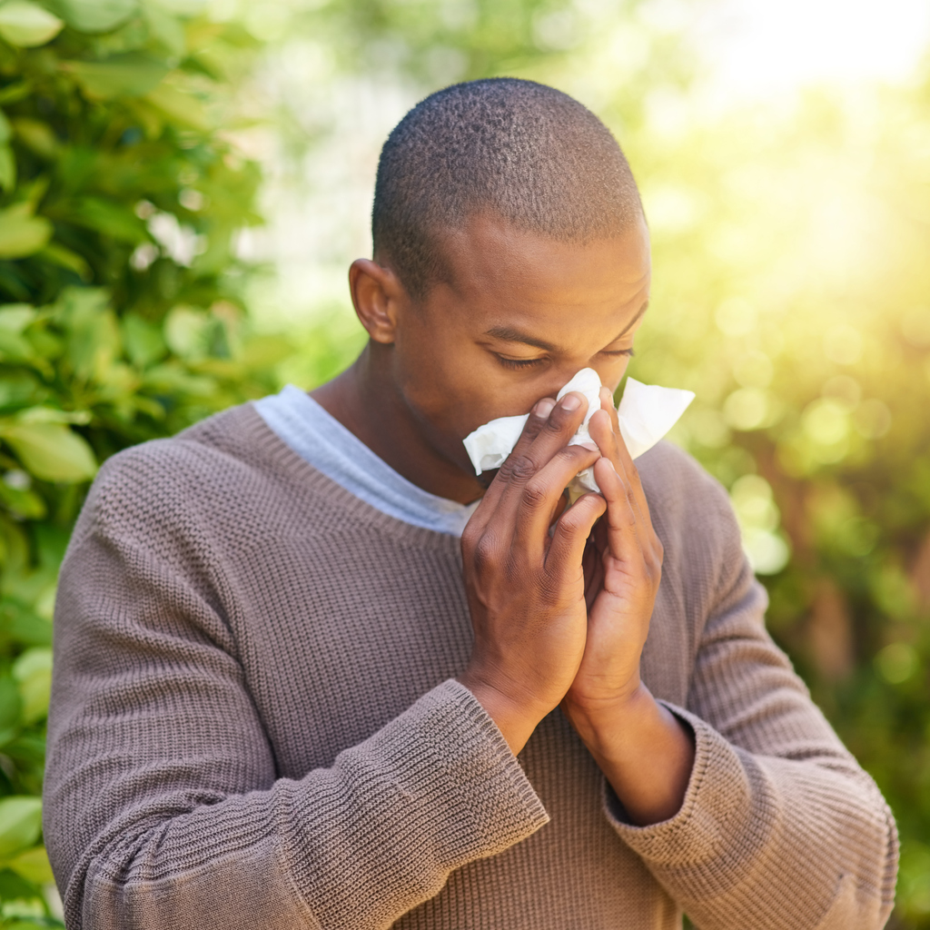 Man Blowing nose with tissue