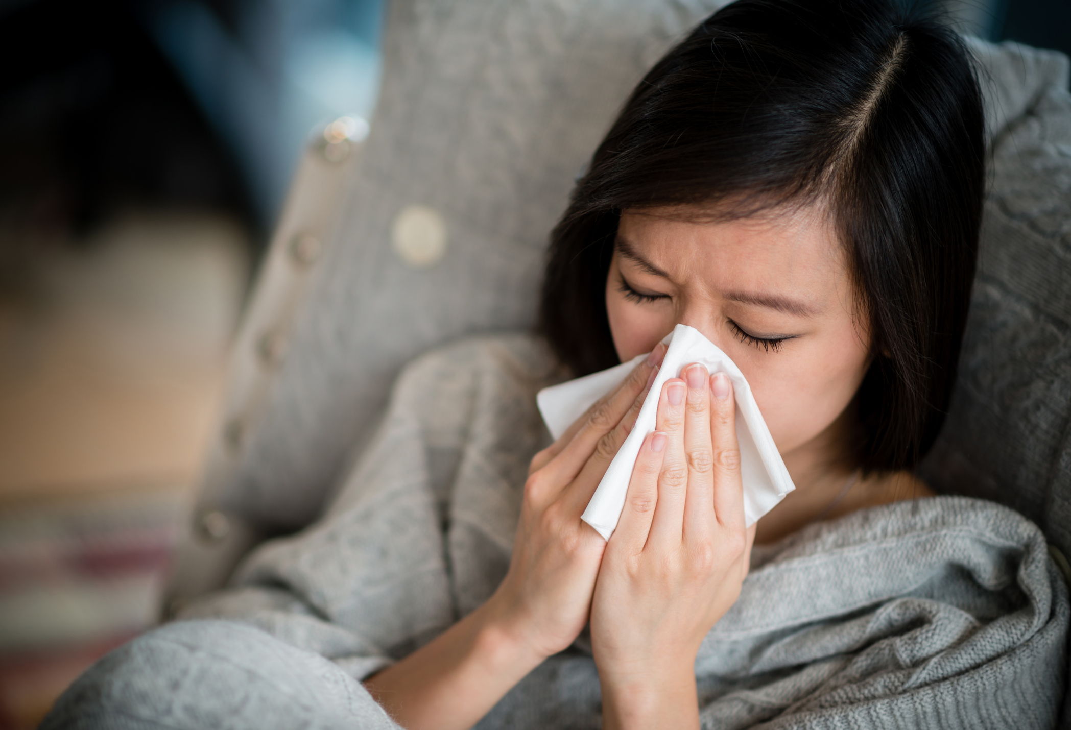 Woman blowing her nose